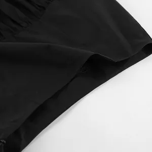 Macro view of black ruffled hem fabric texture on asymmetric French style skirt