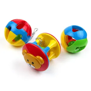 Close-up of colorful plastic bell balls and animal-faced chewing toys for parrots
