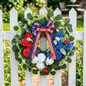 Patriotic American Independence Day wreath with red white blue roses on a white fence