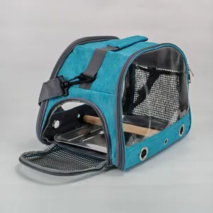Blue portable bird carrier bag with wooden perch and interior metal tray detail view