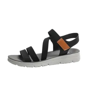 Side view of lightweight black elastic sandals with a comfortable grey platform sole.