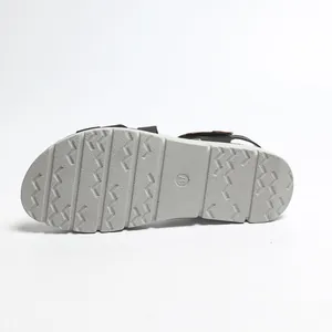 Detailed macro view of the anti-slip wavy outsole on grey lightweight platform sandals.