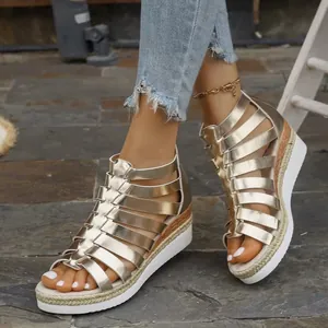 Detail view of champagne gold metallic gladiator wedge sandals with back zipper