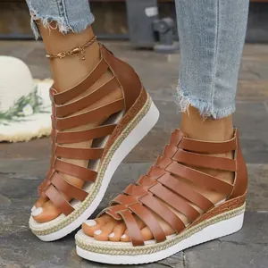 Close-up of brown Roman platform sandals with multiple straps and a rear zipper.