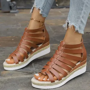 Detail of casual brown Roman gladiator wedge sandals with multi-strap leather design