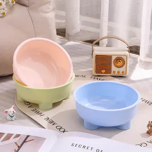 Set of three colorful pastel round pet bowls for cats and dogs in cozy home scene