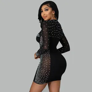 Detailed side view showing a black bodycon dress with sheer mesh and rhinestone studs