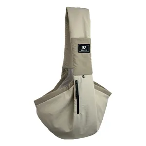 Detailed view of the lightweight beige pet sling carrier with breathable mesh lining.