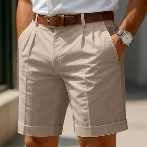 Detailed macro view of khaki pleated business casual shorts for men featuring a cuffed hem