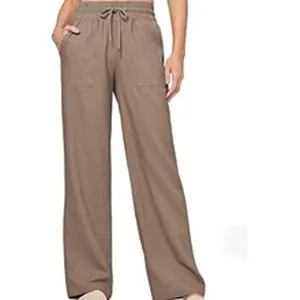 Detail view of brown wide-leg trousers showing drawstring waist and side pockets