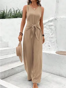 Stylish wide-leg sleeveless jumpsuit with waist knot detail shown on model outdoors.