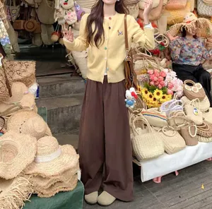 Yellow knit cardigan with dog embroidery and colorful buttons in a casual style