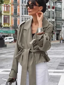 Elegant autumn short trench jacket for women featuring large lapels and belted waist style