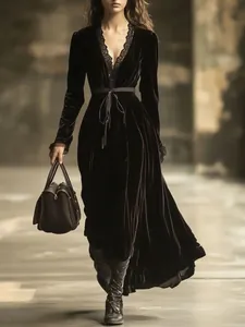 Elegant detail of French vintage velvet maxi dress with lace V-neckline and waist belt