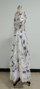 Side view showing the silhouette of a floral tiered organza long dress on a mannequin.