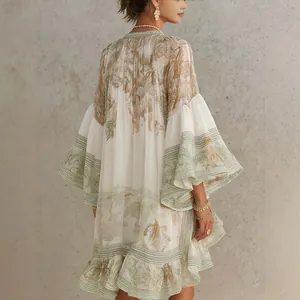 Close-up detail of a bohemian floral print mini dress featuring elegant ruffle hem and bell sleeves
