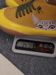 Detailweergave van hoge kattenschoen die 347,8 g weegt op een digitale weegschaal