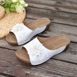 Elegant white wedge slippers for women with decorative 3D flower and laser-cut details