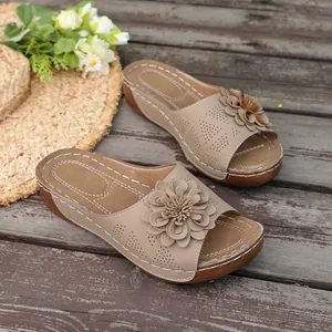 Side detail of women's summer wedge slippers featuring a multi-layered flower accent