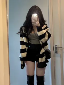Oversized black and white striped knitted cardigan styled in a Korean casual look