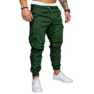 Detail view of men's dark green multi-pocket cargo pants with jogger cuffs