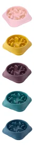 Detailed view of multi-colored slow-feed pet bowls with anti-choke design features.