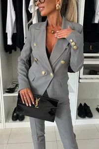 Detailed view of elegant women's grey double-breasted professional blazer and trousers set