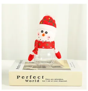 Macro view of a snowman Christmas candy jar made of clear plastic and soft red plush.