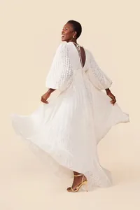 Full back view of white lantern sleeve maxi dress showing flowy pleated jacquard hem