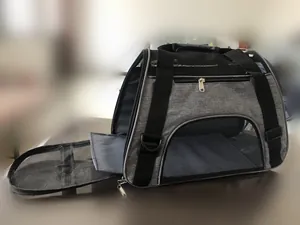 Detailed view of a grey breathable mesh pet carrier bag for travel and outdoors.