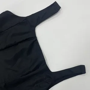 Close-up of elegant black sleeveless square neck dress with fine fabric texture