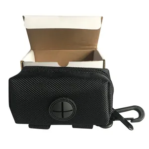 Detail view of black dog waste bag dispenser with rubber dispensing port and clip