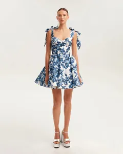 Ethereal blue and white floral organza dress with tie-shoulder straps and flared skirt
