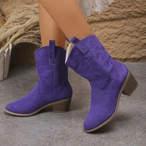 Side view of purple faux suede cowboy boots with embroidered details and chunky heel