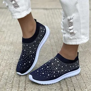Vista dettagliata di sneaker blu navy in maglia con strass brillanti sulla modella