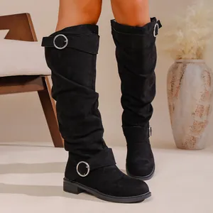 Detail view of stylish black slouchy knee-high boots with elegant silver buckle straps
