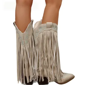 Vintage Western cowboy boots with long fringe tassels and blue embroidery details