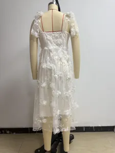 Detailed back view of white lace patchwork evening dress featuring floral embroidery detail