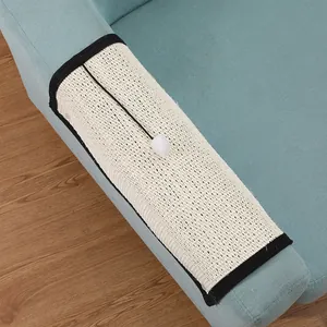 Durable sisal cat scratching mat for sofa armrest protection with interactive pom-pom toy.
