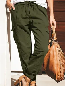 Detail view showing olive green cargo pants with drawstring waist and side pockets
