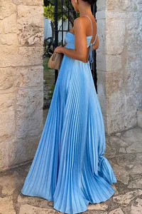 Close-up view of a light blue pleated maxi dress featuring an elegant backless tie design