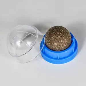 Close-up view of a compressed catnip ball toy featuring a blue base and clear cap