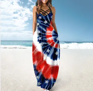 Sleeveless summer maxi dress with tie-dye patterns and star prints in a beach setting.