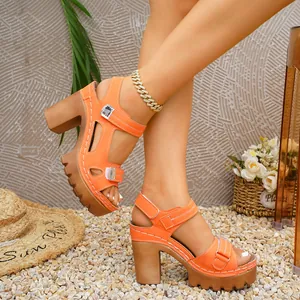 Detail of orange platform sandals with chunky heels and adjustable velcro straps