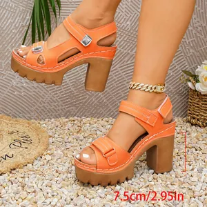 Detail of orange platform sandals with 7.5cm chunky heel and velcro straps.