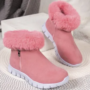 Close-up detail of plush pink faux fur collar and suede finish on warm winter snow boots