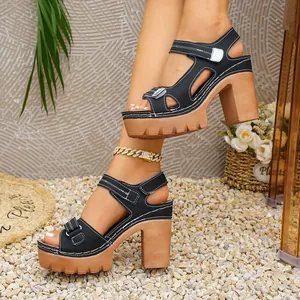 Side view of stylish black platform sandals featuring chunky tan heels and velcro straps.
