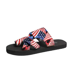 Detail view of a comfortable flat slide sandal with American flag patterned straps.