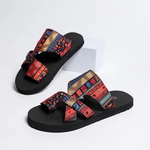 Close-up of women's flat thong sandals featuring vibrant ethnic geometric patterned fabric straps