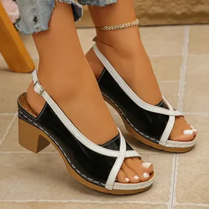 Detail view of black and white color block mid-heel sandals for women